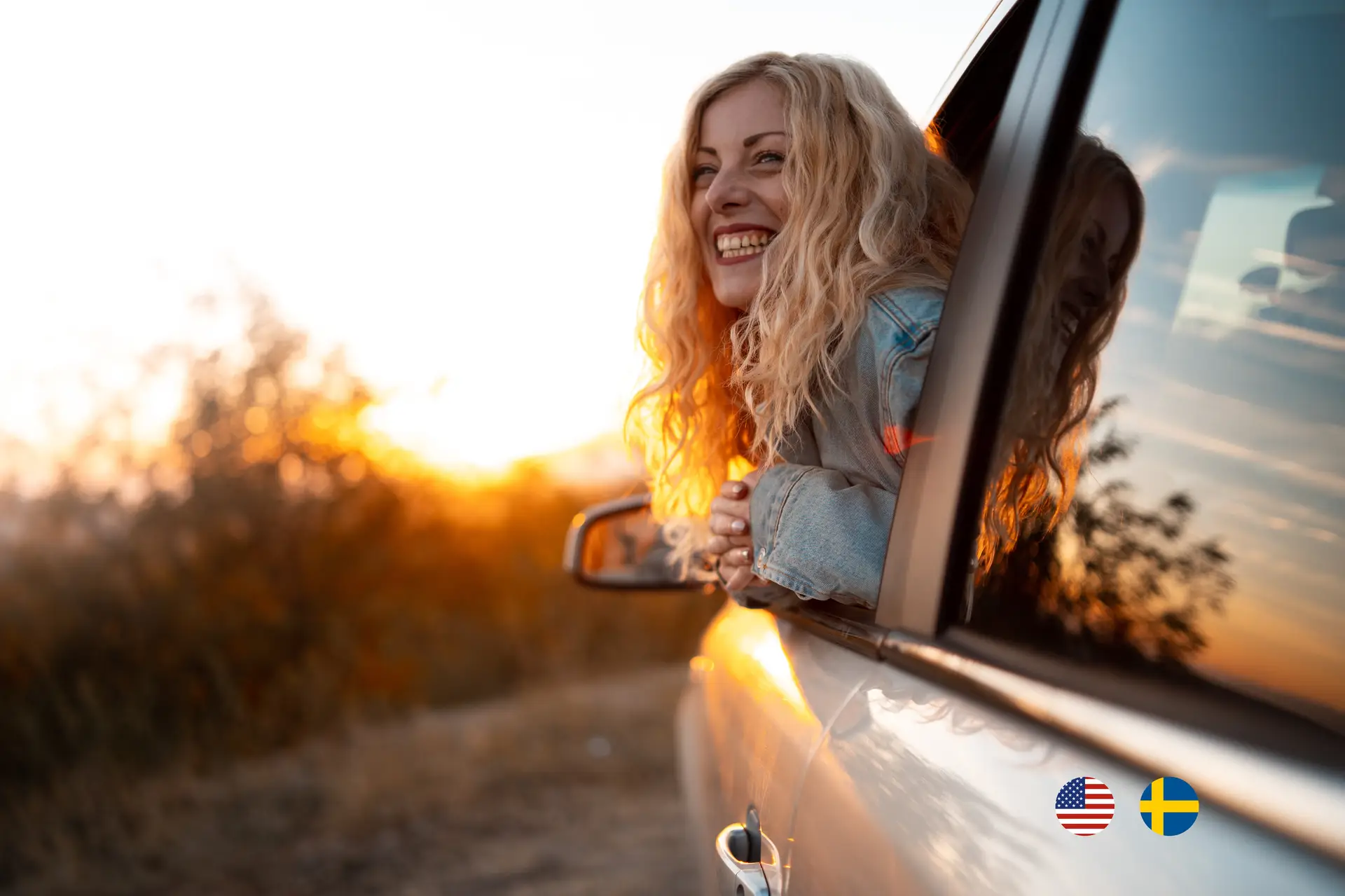 Woman inside a car leaning out of the window to catch the sunset with her face.