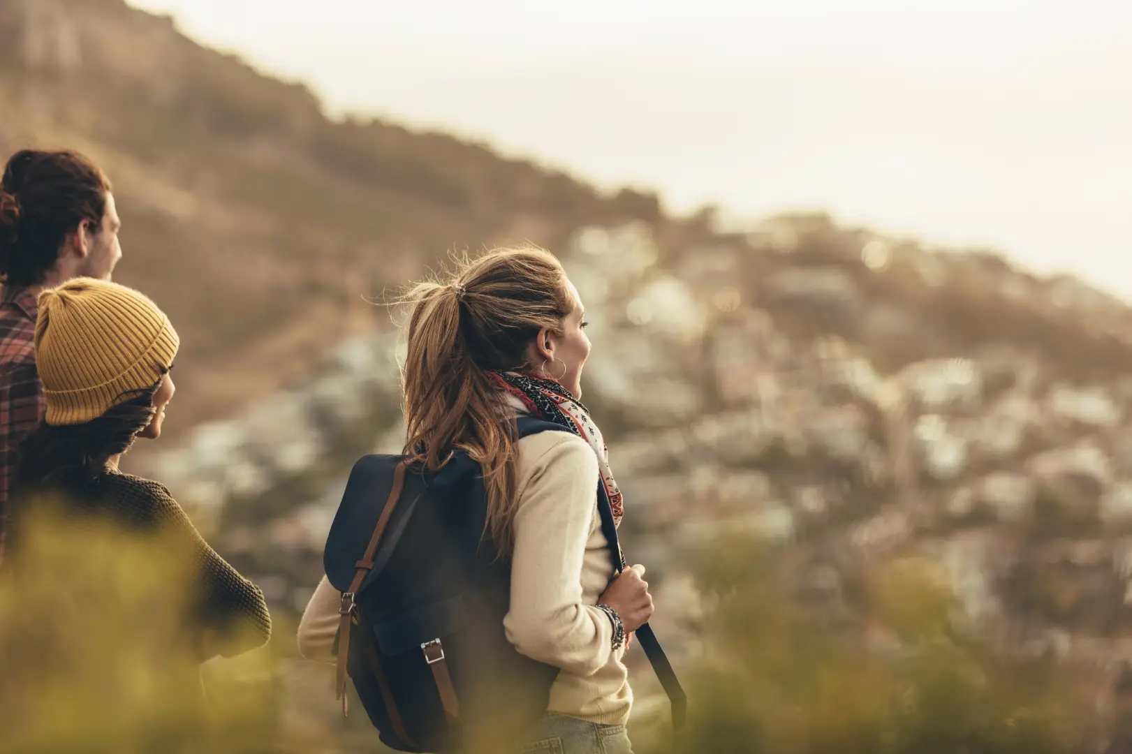 Three persons hiking on a mountain.
